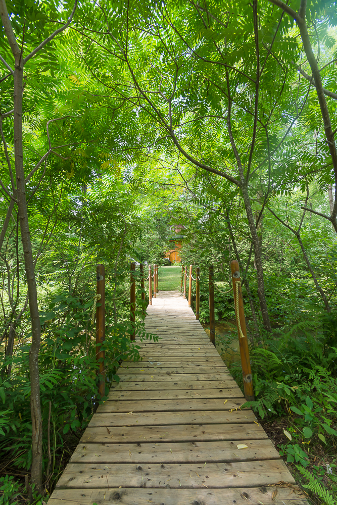 Ponderosa Ranch Resort, Log Cottage and Cabin in Canada Ontario, Summer Season, foot bridge to Log House